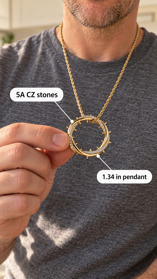 A man in a grey T-shirt holds out the gold Crown of Thorns pendant, with callouts for the 5A CZ stones and the 1.34 inch size.