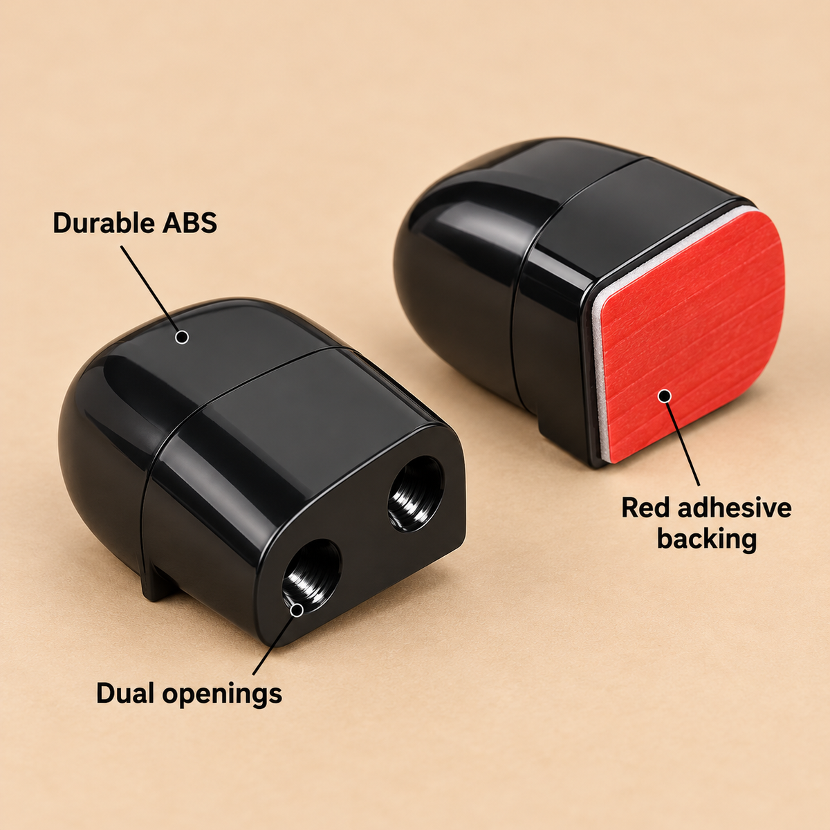Close-up of two deer whistles showing the two openings and the red adhesive backing.