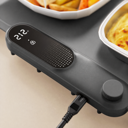 Close-up of the food warming mat's control module with its glowing LED display and round knob.