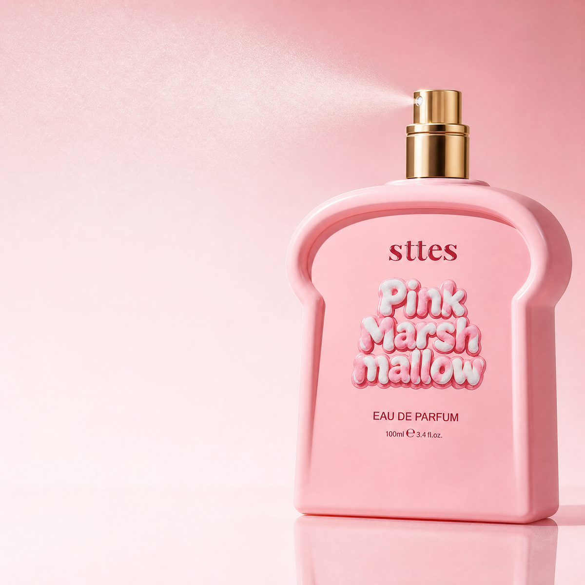 The pink Marshmallow eau de parfum bottle releasing a fine mist from its gold nozzle on a soft pink background.