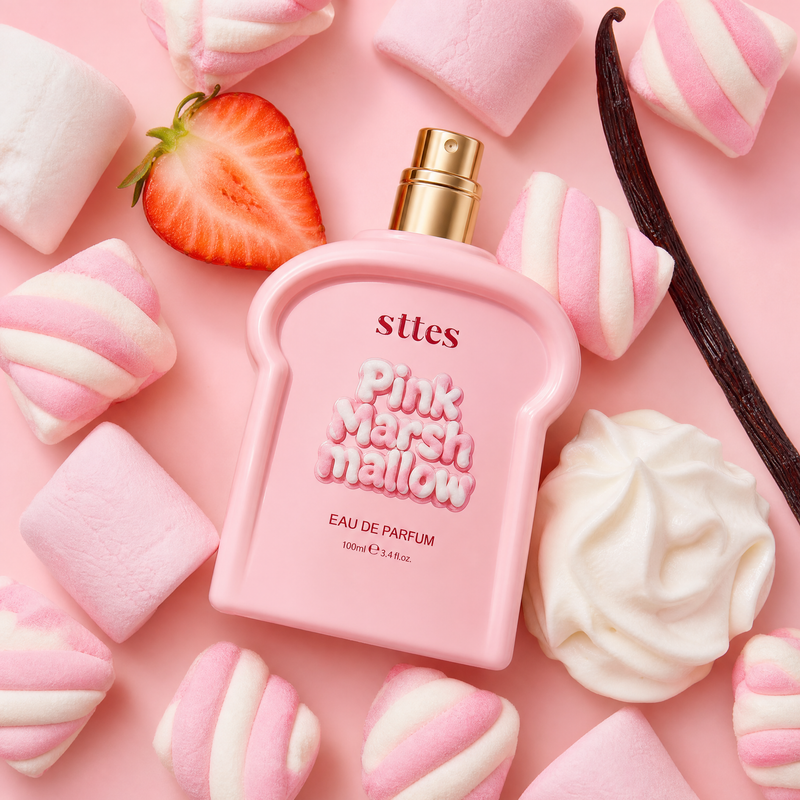 Overhead flatlay of the pink marshmallow perfume with marshmallows, strawberry, vanilla and whipped cream.